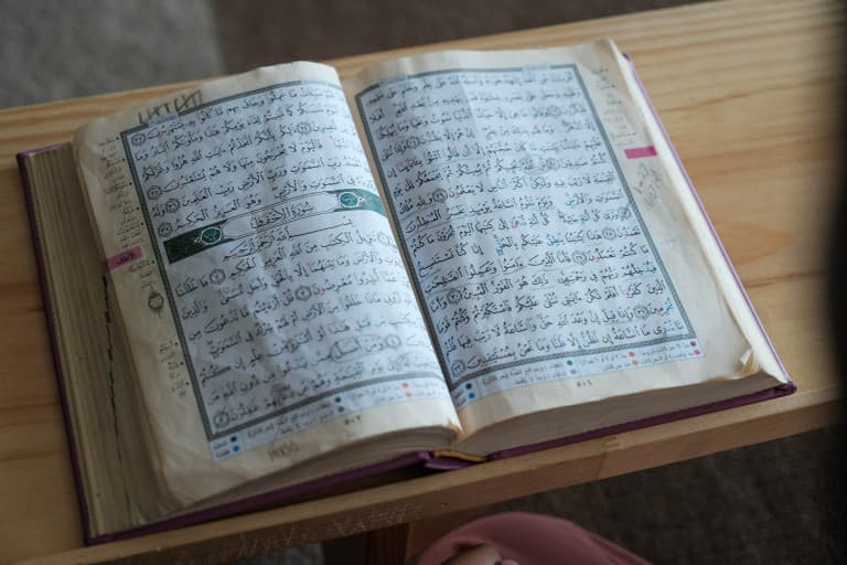 Open Quran on a wooden desk
