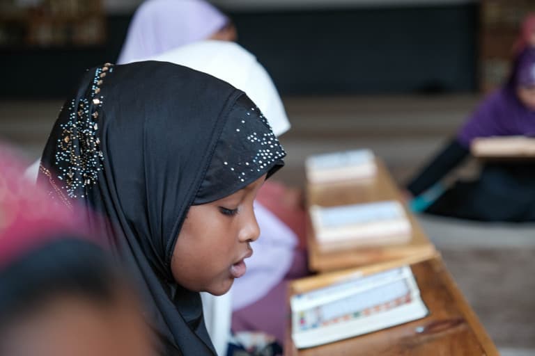 Girl reciting the Quran in class