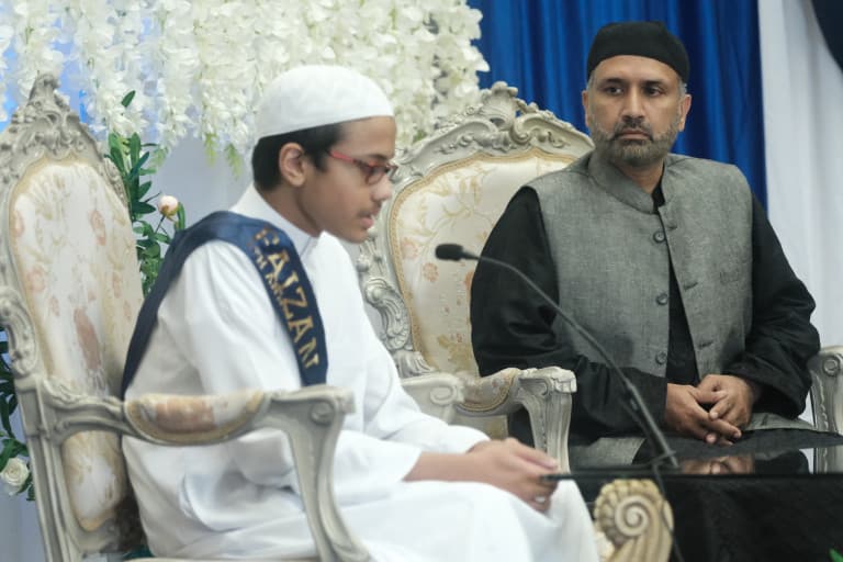 Student reciting beside a judge at an Abu Huraira Center Quran competition
